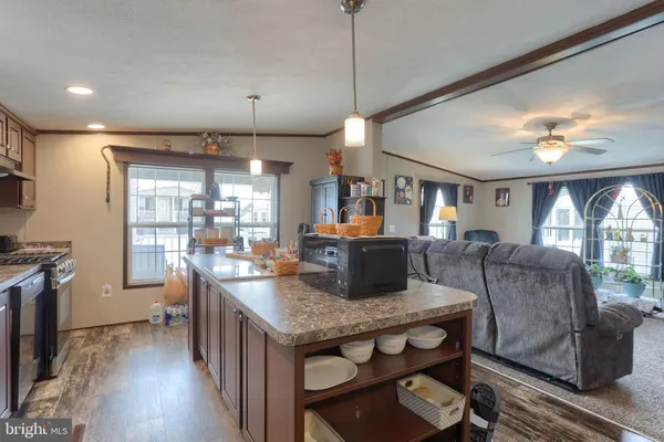 a dining room with furniture a chandelier and window