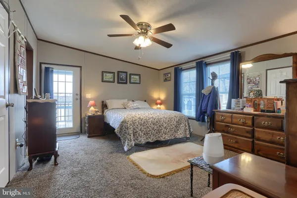 a bedroom with a bed and dresser with mirror