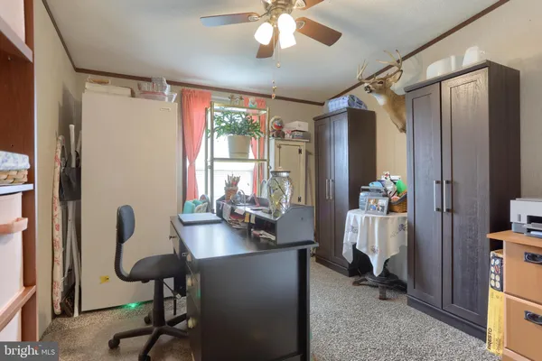 a view of a workspace with furniture and a window