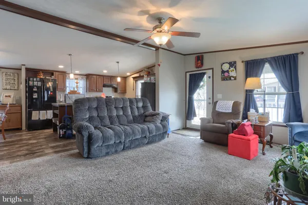 a living room with furniture and kitchen view