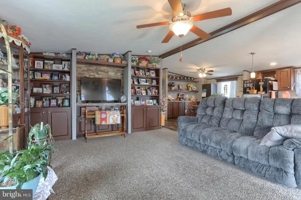 a living room with furniture and a bookshelf