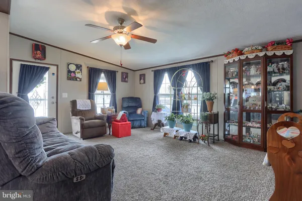 a living room with furniture a chandelier and a large window