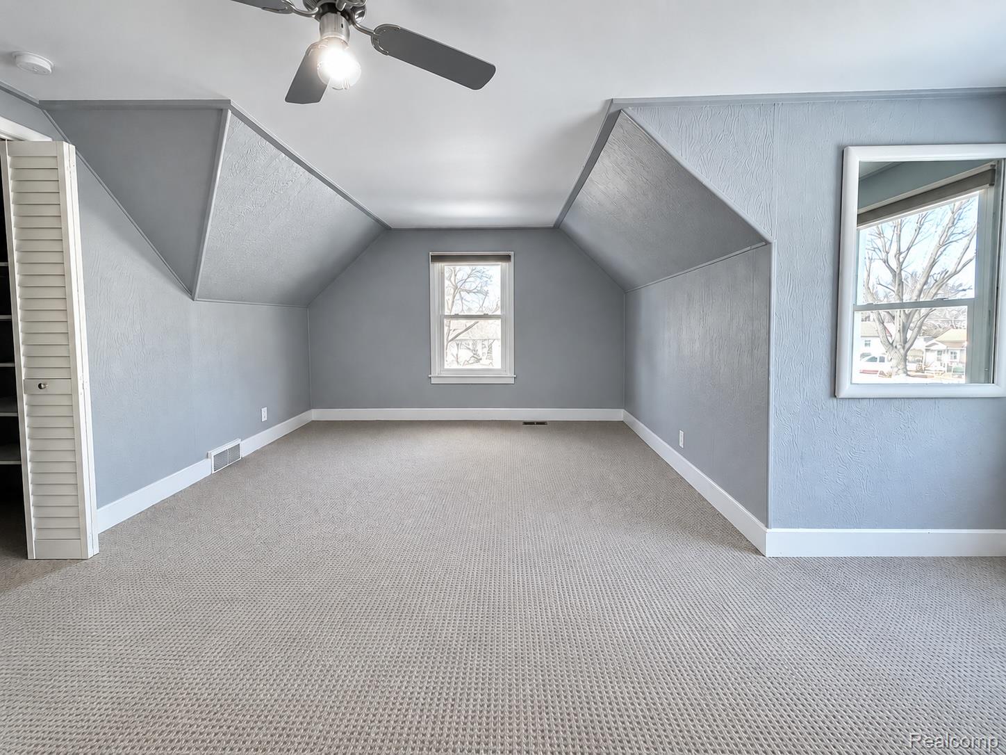 21761 Middlebelt Road Farmington, MI 48336 - Photo 9 of 21 Sloped ceilings, neutral tone walls, and white trim accents