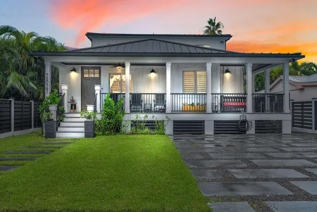 front view of a house with a large window and a yard
