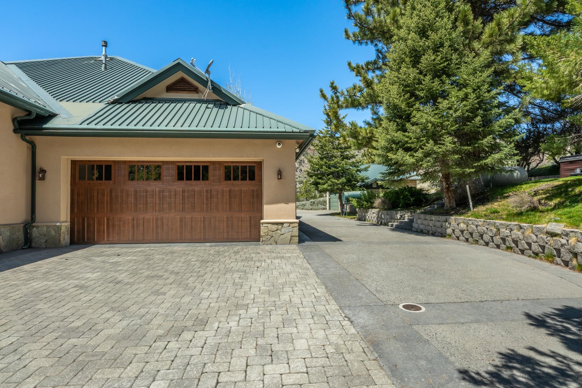 45 Skyline Road June Lake, CA 93529 - Photo 50 of 58 a front view of a house with a yard and garage