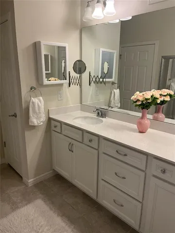 a bathroom with a double vanity sink and mirror