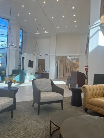 a view of a patio with table and chairs floor to ceiling window with wooden floor