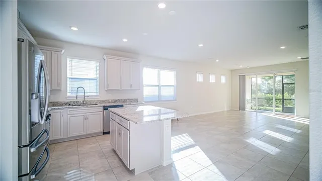 a kitchen with granite countertop a sink stove and cabinets