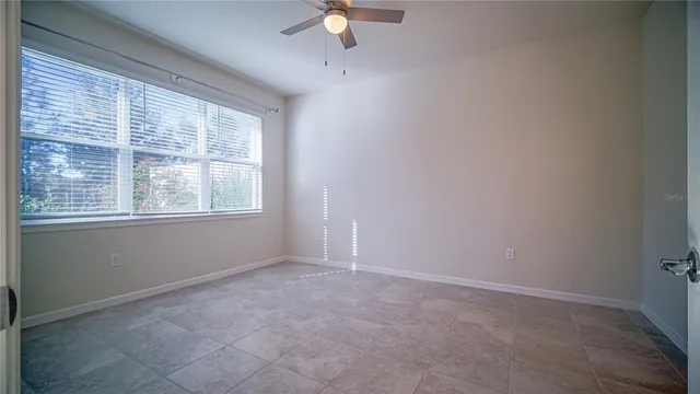 a spacious bathroom with a granite countertop sink and a mirror