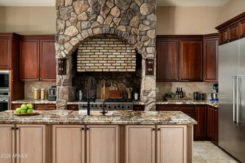 a kitchen with stainless steel appliances granite countertop a sink and cabinets