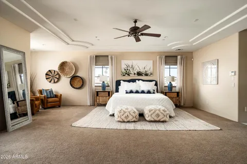 a bedroom with a large bed and a chandelier