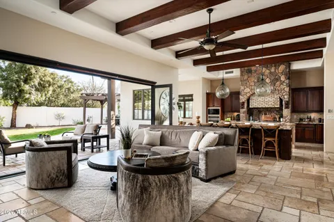 a living room with lots of furniture and a large window