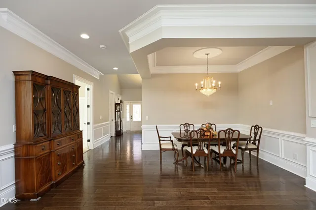 a view of a a dining room with furniture window and wooden floor