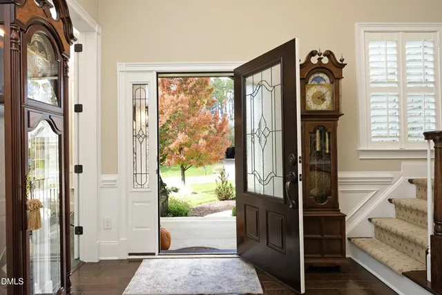 a view of an entryway with wooden floor and a livingroom