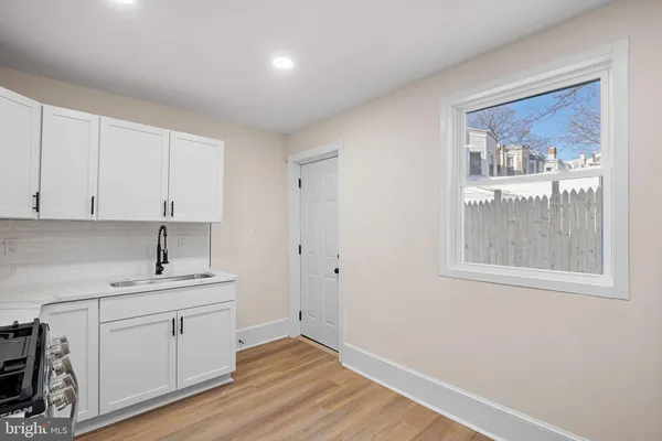 a kitchen with a refrigerator stove and microwave
