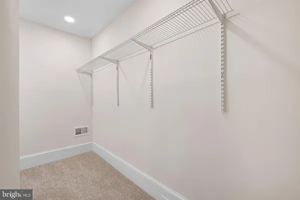 view of an empty room with mirror and a window