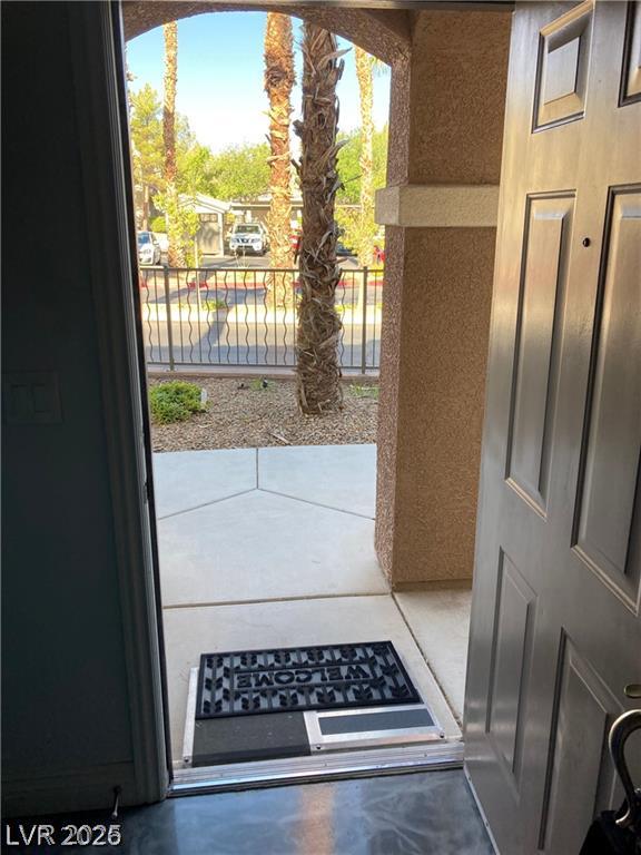 9050 West Warm Springs Road, Unit 1027 Las Vegas, NV 89148 - Photo 3 of 44 An inviting entryway reveals lush landscaping and open parking just beyond the front door.