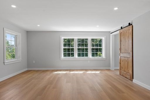 203 Taylor Road Ashby, MA 01431 - Photo 15 of 30 an empty room with wooden floor and windows