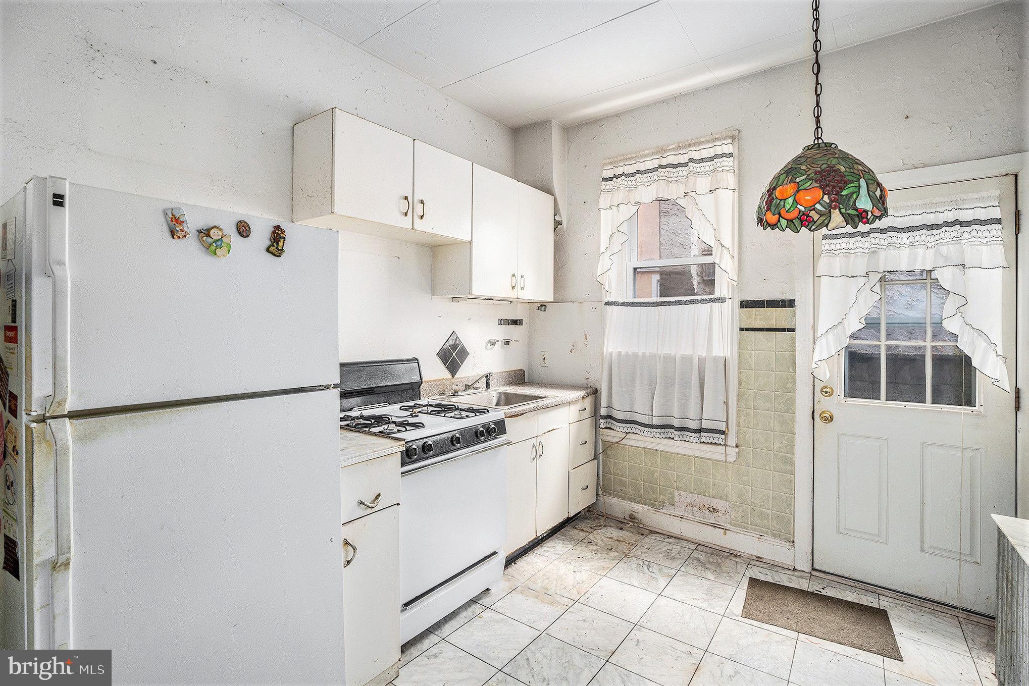 527 Christian Street Philadelphia, PA 19147 - Photo 7 of 28 a kitchen with stainless steel appliances granite countertop a refrigerator a stove and a sink
