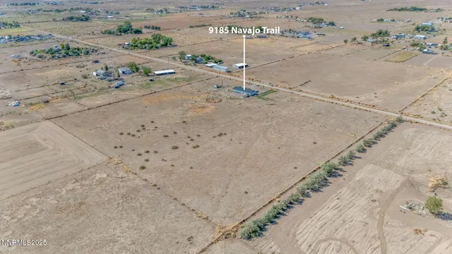a living room with stainless steel appliances furniture a table and chairs
