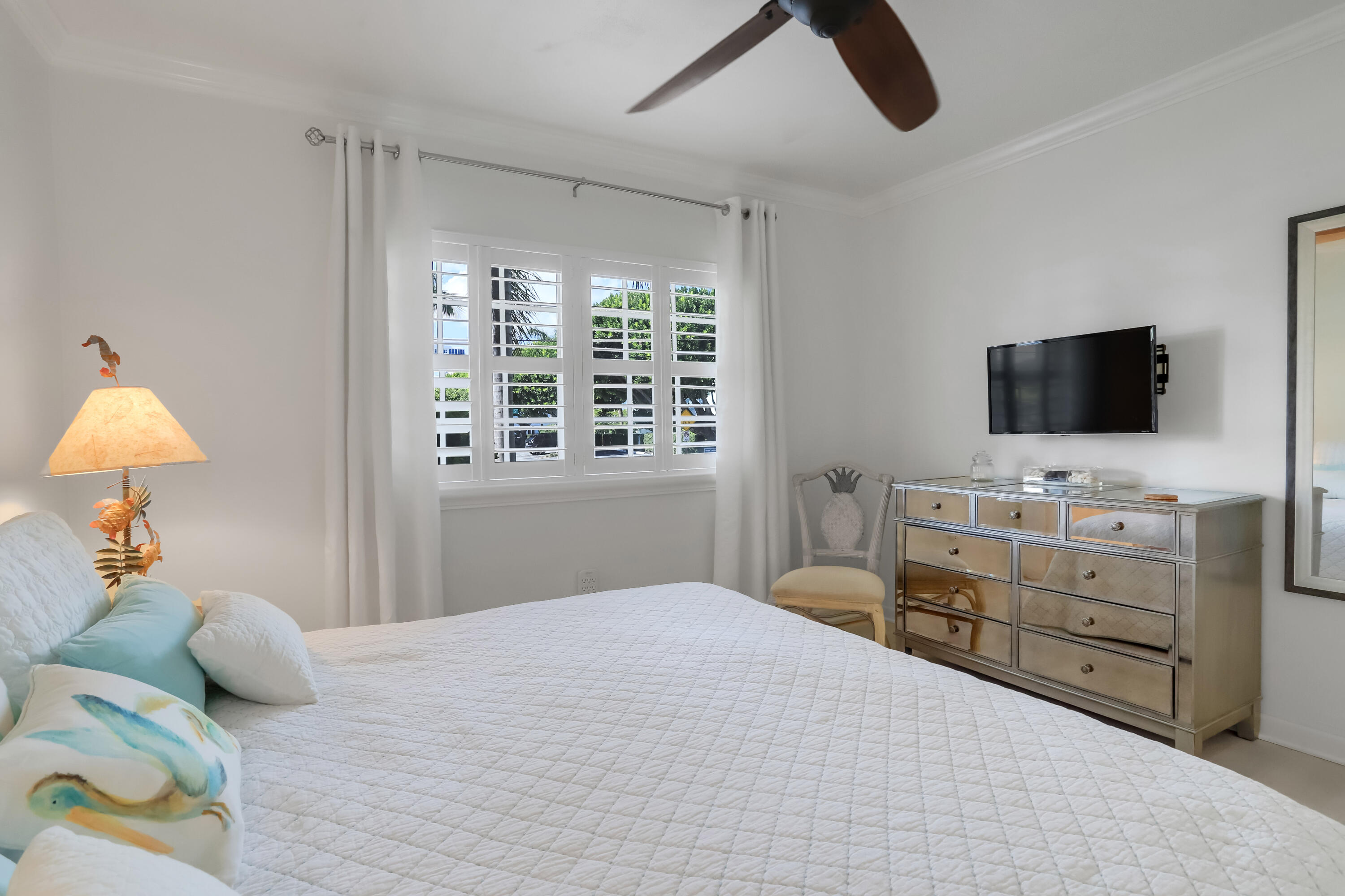 217 Gleason Street, Unit A Delray Beach, FL 33483 - Photo 15 of 28 a bedroom with a bed and flat screen tv