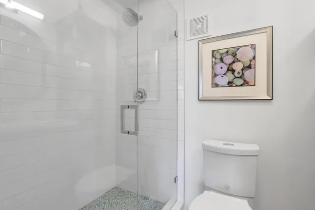 a bathroom with a toilet and a shower