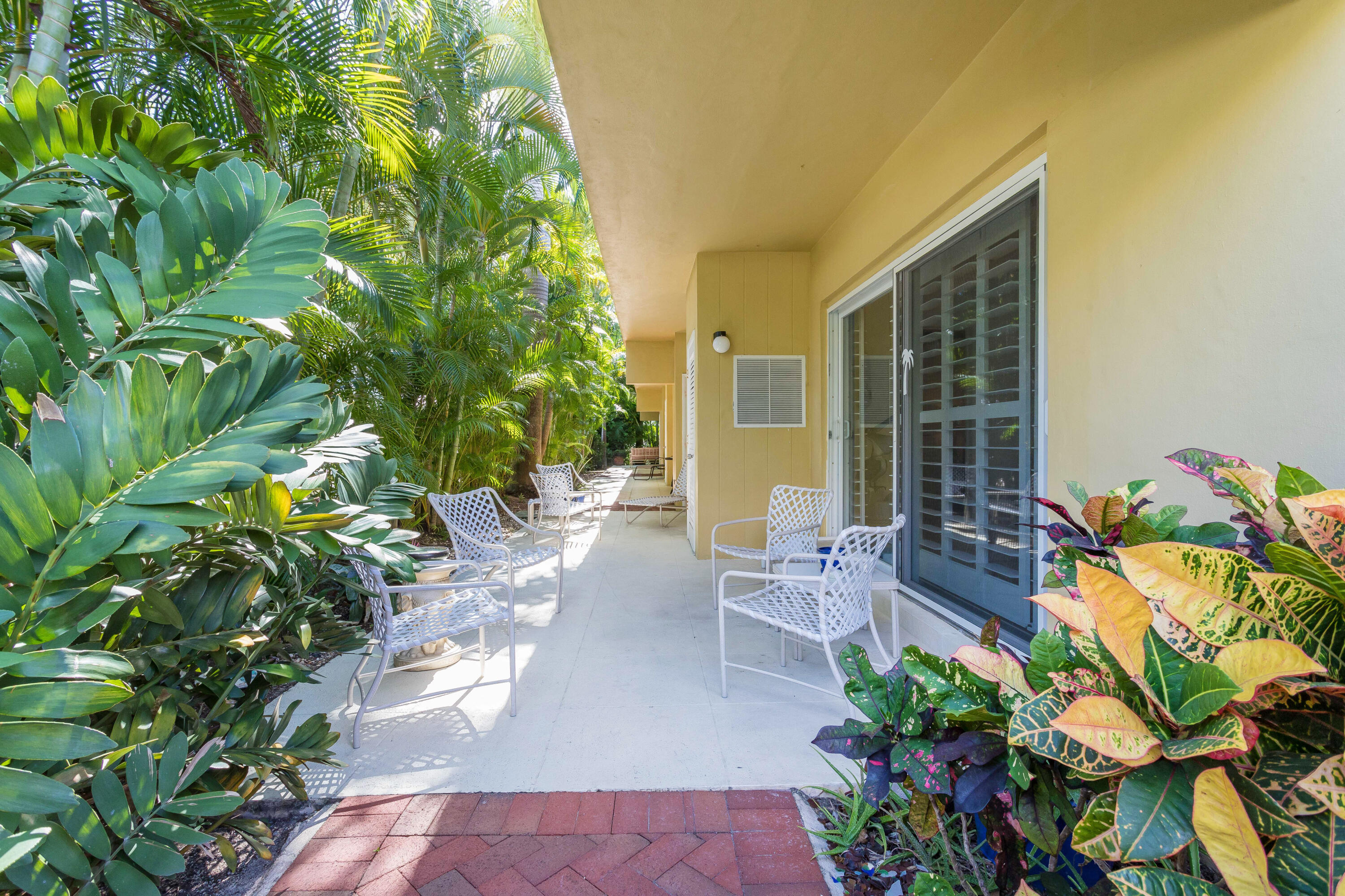 217 Gleason Street, Unit A Delray Beach, FL 33483 - Photo 19 of 28 a view of a patio with table and chairs and potted plants