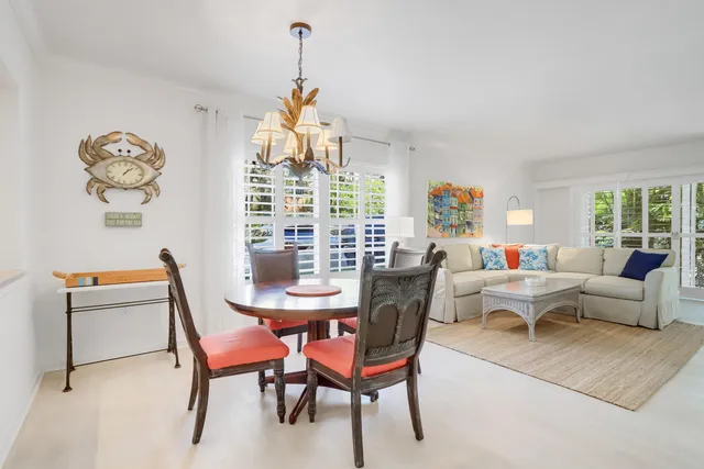 a living room with furniture a rug and a large window