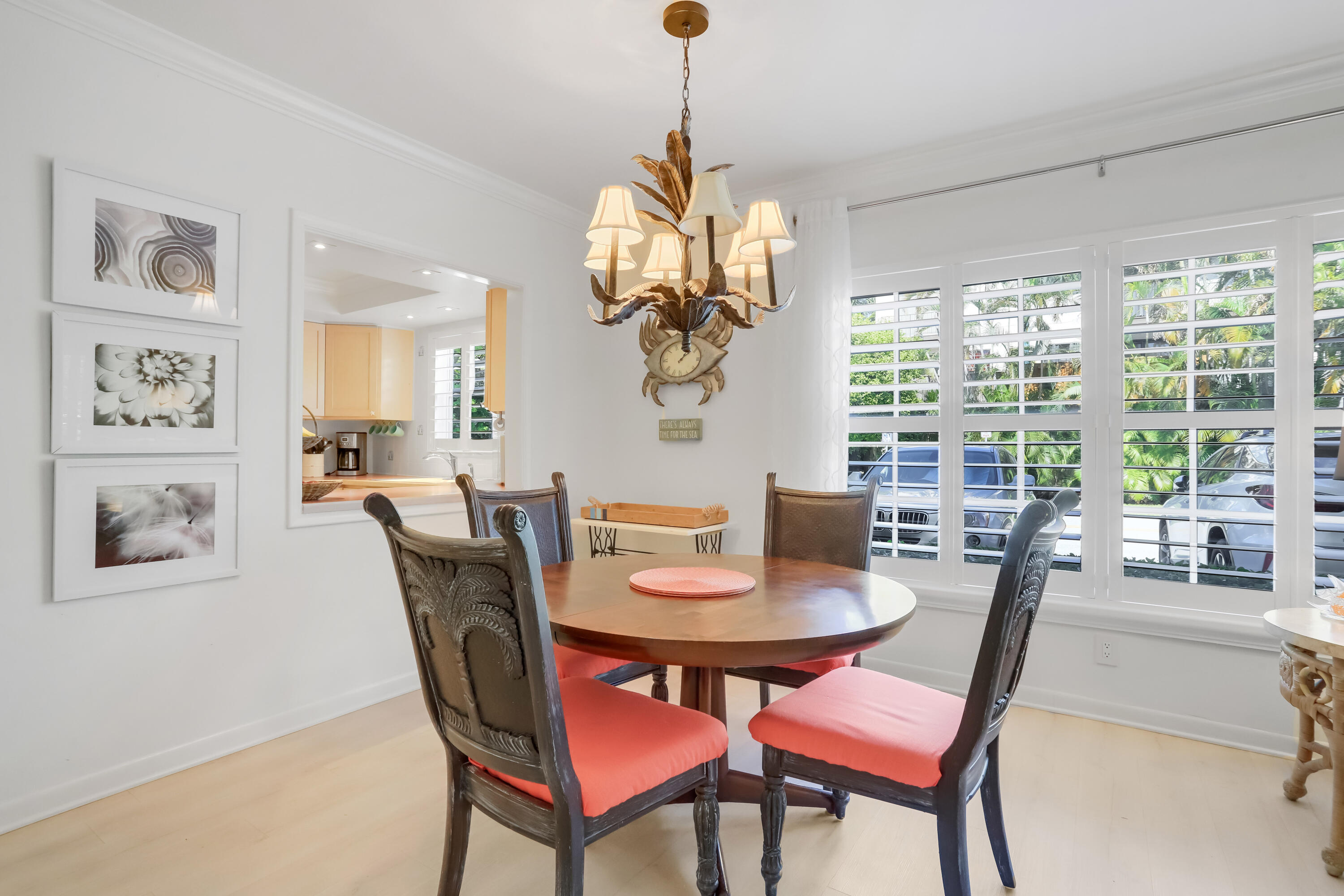 217 Gleason Street, Unit A Delray Beach, FL 33483 - Photo 7 of 28 a dining room with furniture a large window and a chandelier