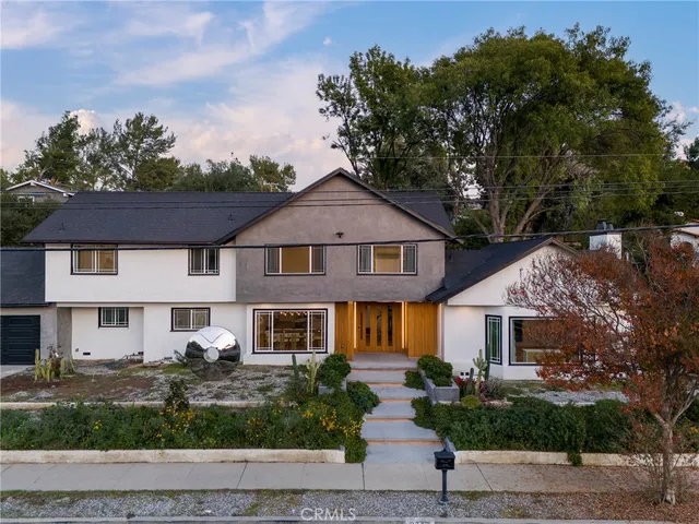a front view of a house with a garden