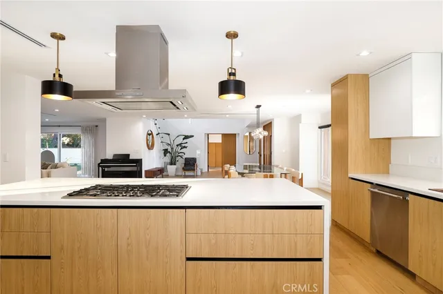 a kitchen with kitchen island granite countertop a sink and a refrigerator