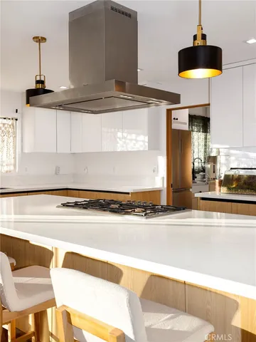 a kitchen with a stove and a refrigerator