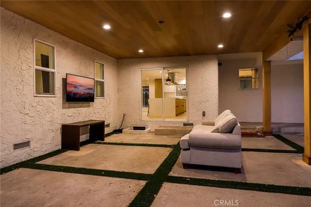 a bedroom with furniture and a flat screen tv