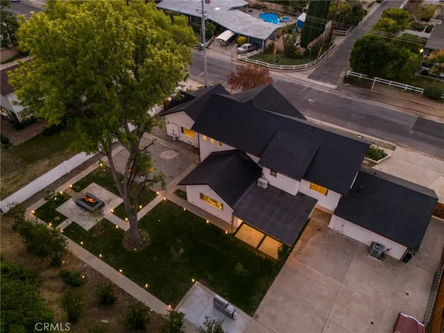 an aerial view of a house with a yard