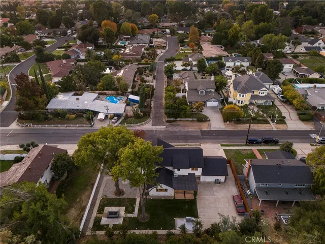 an aerial view of a house with yard swimming pool and outdoor seating