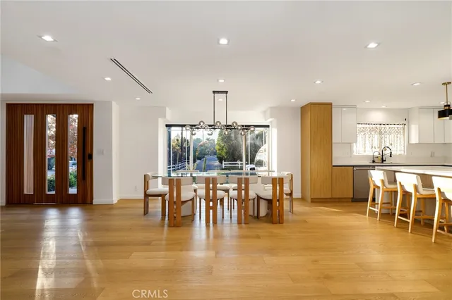 a dining room with furniture window and wooden floor