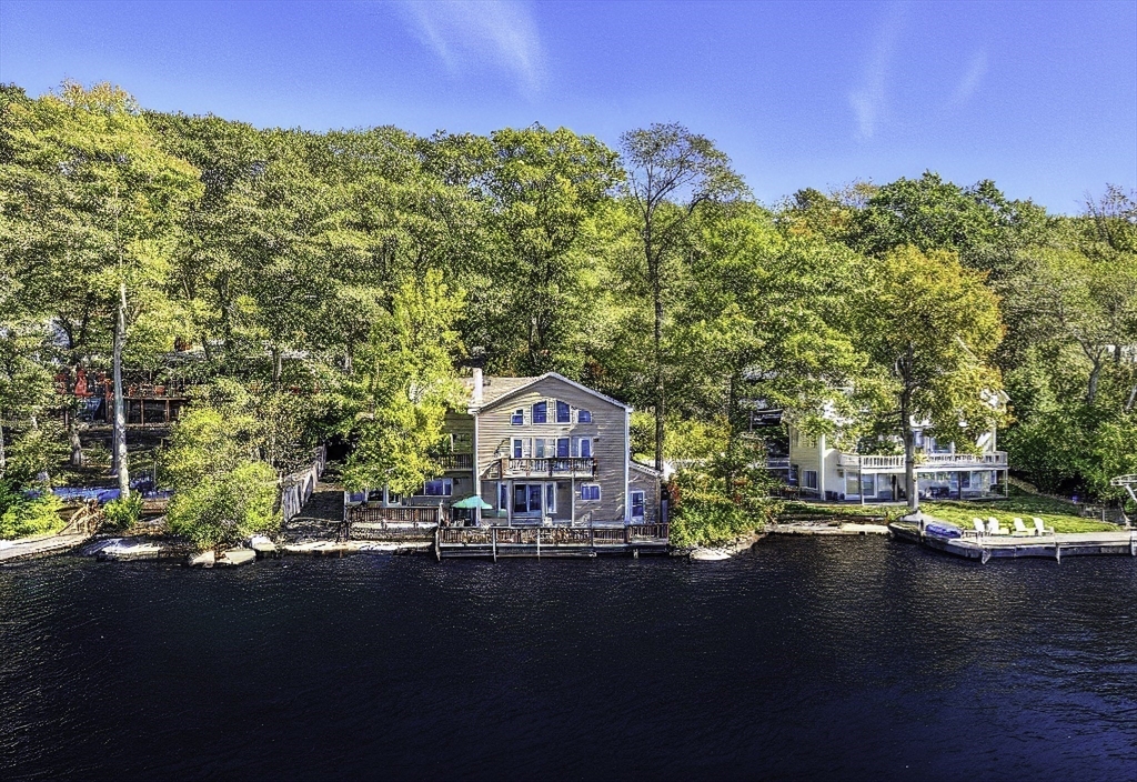 28 Downey Street Hopkinton, MA 01748 - Photo 1 of 39 a view of a lake with a mountain in the background