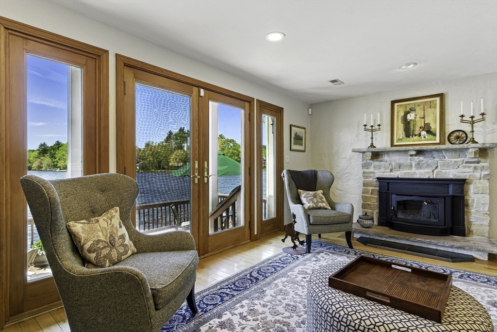 28 Downey Street Hopkinton, MA 01748 - Photo 14 of 39 a living room with furniture a large window and a fireplace