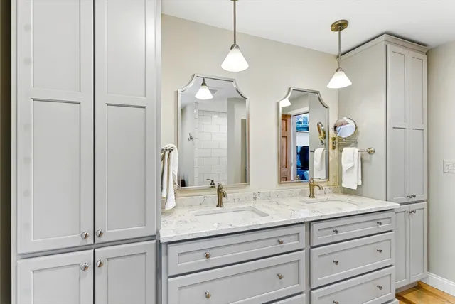 a white toilet sitting next to a bathroom sink