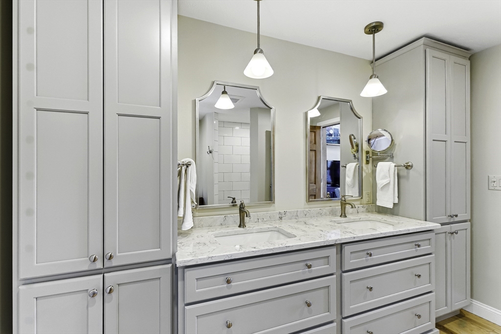 28 Downey Street Hopkinton, MA 01748 - Photo 18 of 39 a bathroom with a granite countertop sink a mirror and a shower