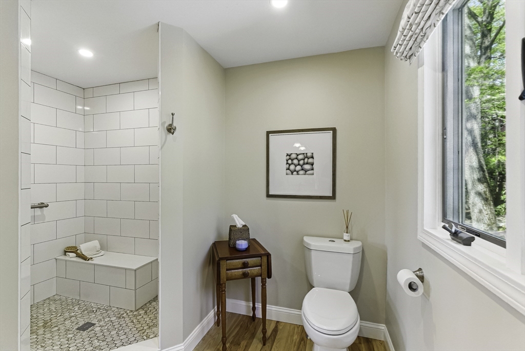 28 Downey Street Hopkinton, MA 01748 - Photo 19 of 39 a white toilet sitting next to a bathroom sink