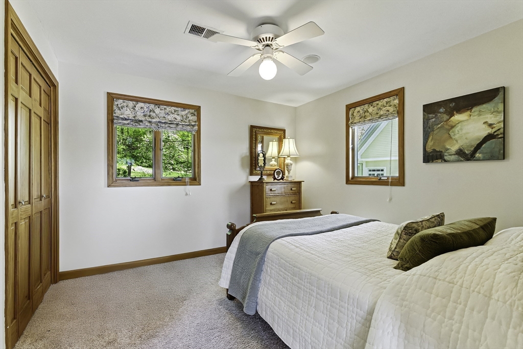 28 Downey Street Hopkinton, MA 01748 - Photo 20 of 39 a bedroom with a bed and a painting on the wall