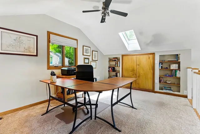 a bedroom with furniture and a large window