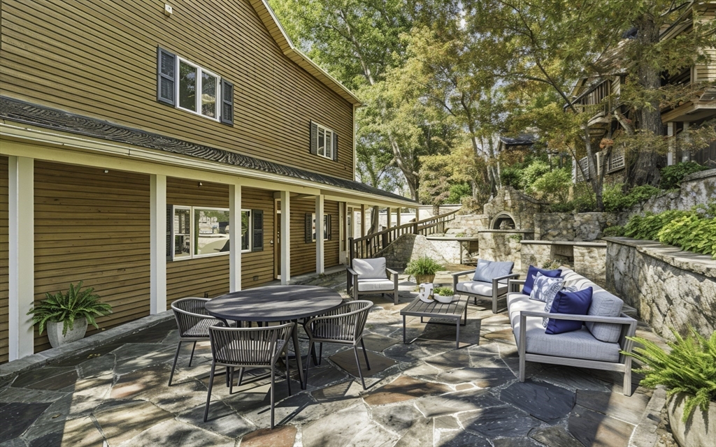 28 Downey Street Hopkinton, MA 01748 - Photo 5 of 39 a backyard of a house with outdoor seating
