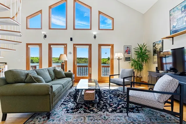 a living room with furniture fireplace and a large window
