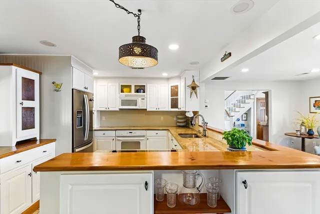 a large white kitchen with a large window