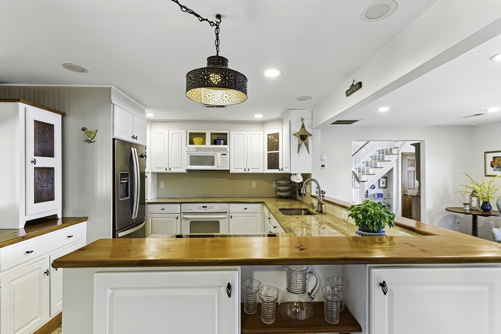 28 Downey Street Hopkinton, MA 01748 - Photo 9 of 39 a kitchen with a sink appliances and cabinets