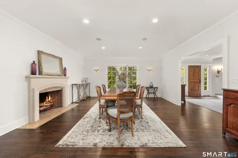 a living room with furniture a fireplace and wooden floor
