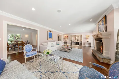 a living room with furniture fireplace and wooden floor