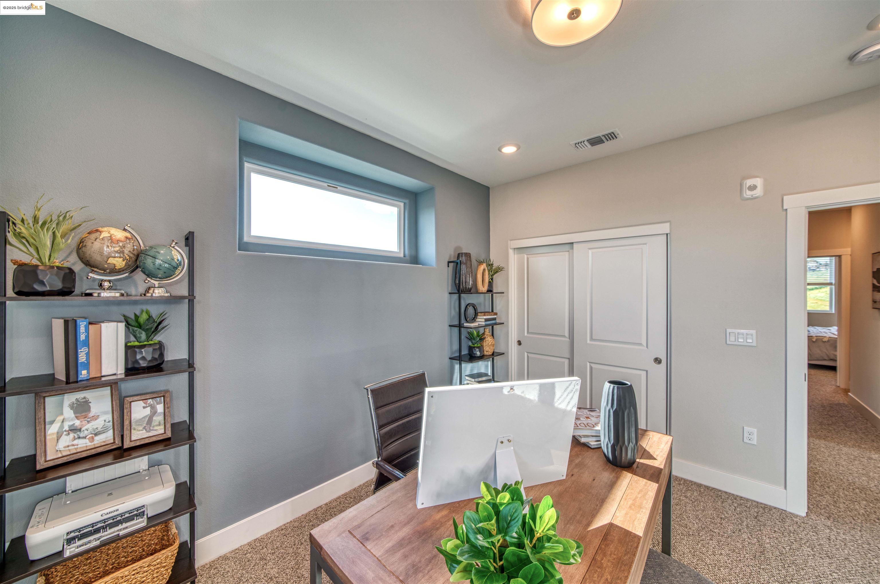 28949 Parkridge Loop, Unit 86 Hayward, CA 94544 - Photo 13 of 15 a living room with furniture a bookshelf and a window